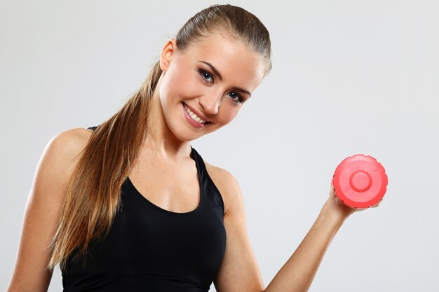 Young woman with dumbells