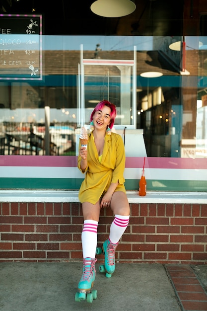Young woman with dyed hair eating ice cream