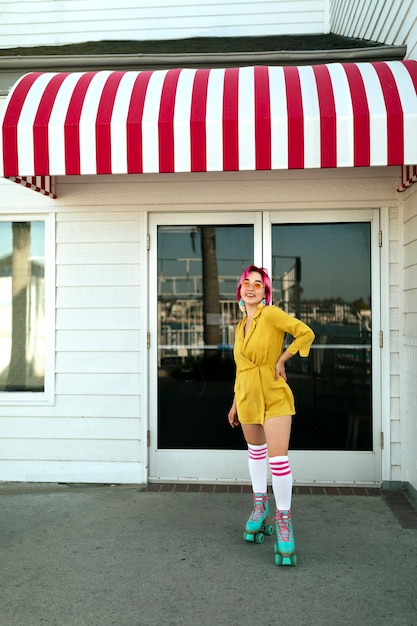 Free photo young woman with dyed hair near shop