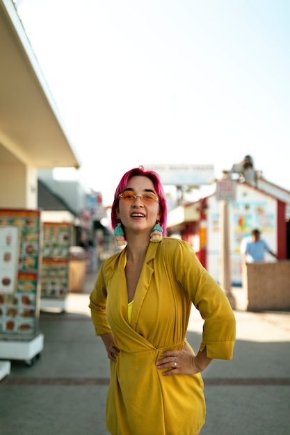 Young woman with dyed hair near shop