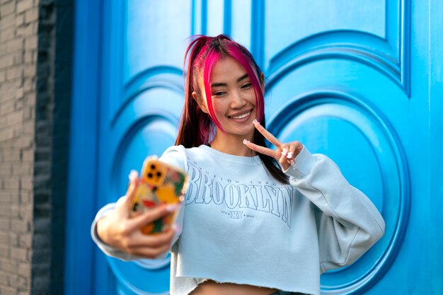 Young woman with dyed hair taking a selfie