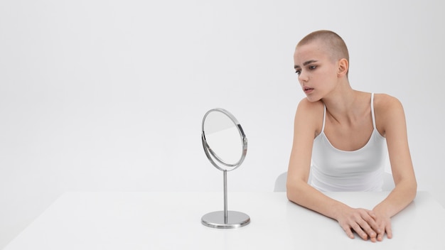 Young woman with an eating disorder checking herself in the mirror