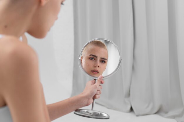 Young woman with an eating disorder checking herself in the mirror