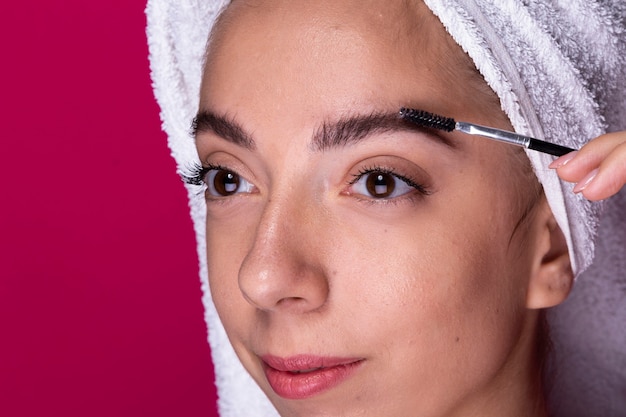 Young woman with eye brush