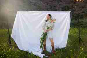 Free photo young woman with gladiolus in nature