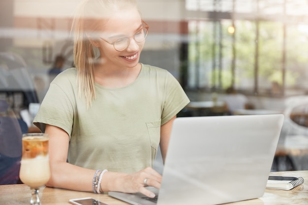 Young woman with glasses in cafe