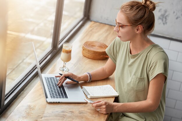 Young woman with glasses in cafe