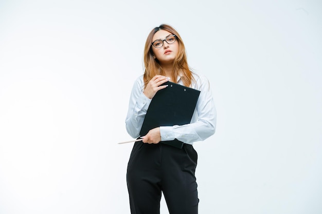 Young woman with glasses holding clipboard