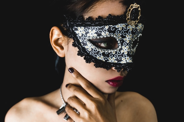 Free photo young woman with a gray venetian mask