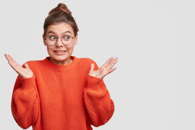 Young woman with hair in a bun wearing a red sweater