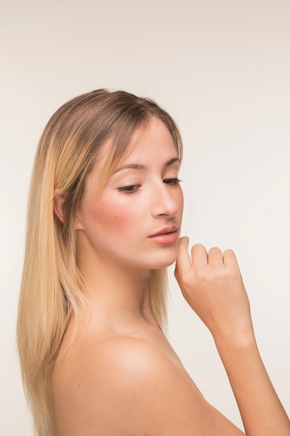 Young woman with hand on the chin pose