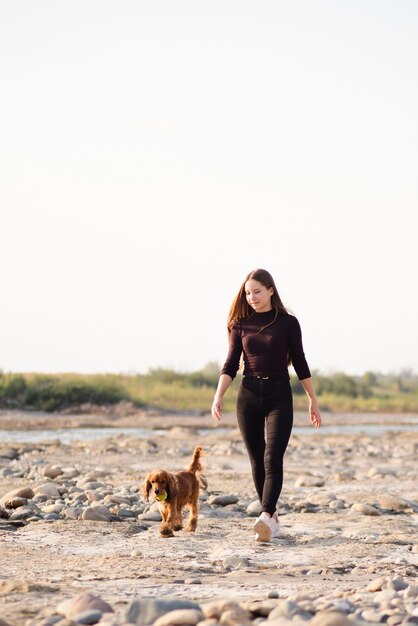 彼女の犬の散歩を持つ若い女性