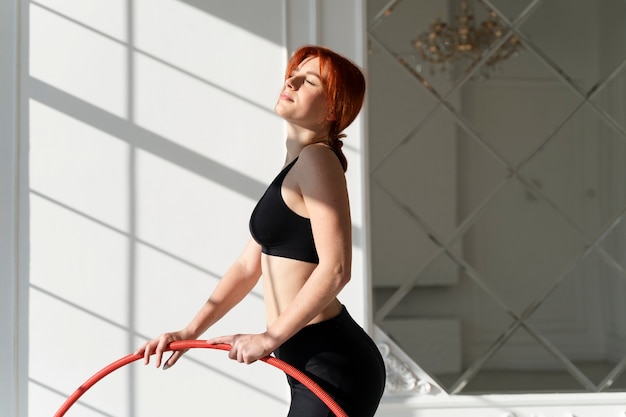 Free photo young woman with hula hoop