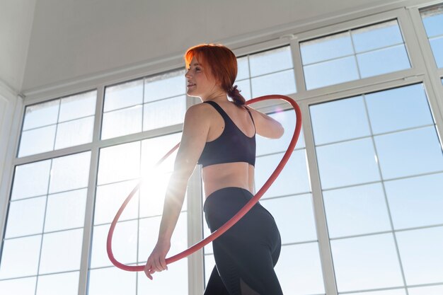 Young woman with hula hoop