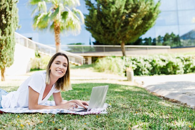 Young woman with laptop looking at camera