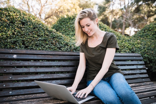 Young woman with laptop in park