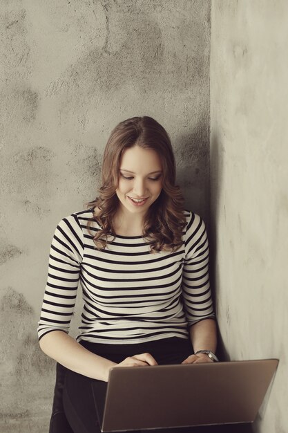 Young woman with laptop pc computer