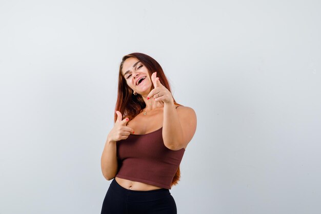 Young woman with long hair in a brown crop top