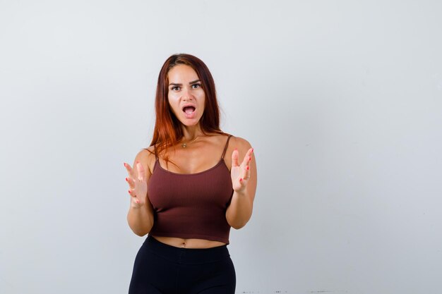 Young woman with long hair in a brown crop top