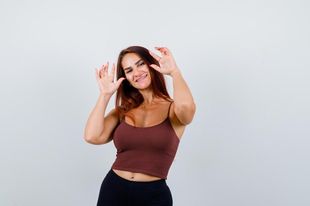 Young woman with long hair in a brown crop top