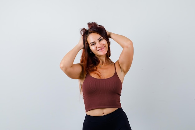 Young woman with long hair in a brown crop top