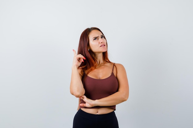 Young woman with long hair in a brown crop top