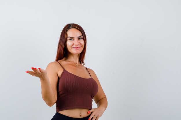 Young woman with long hair in a brown crop top