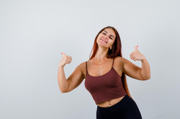 Young woman with long hair in a brown crop top