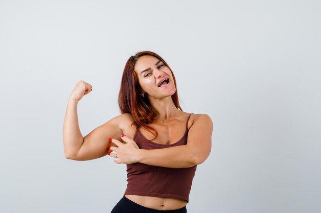 Young woman with long hair in a brown crop top