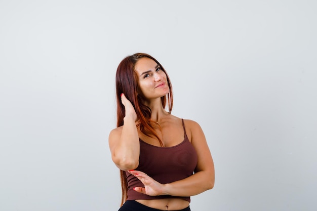 Young woman with long hair in a brown crop top