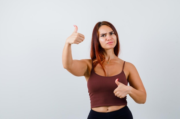 Young woman with long hair in a brown crop top