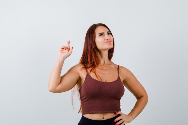 Young woman with long hair in a brown crop top