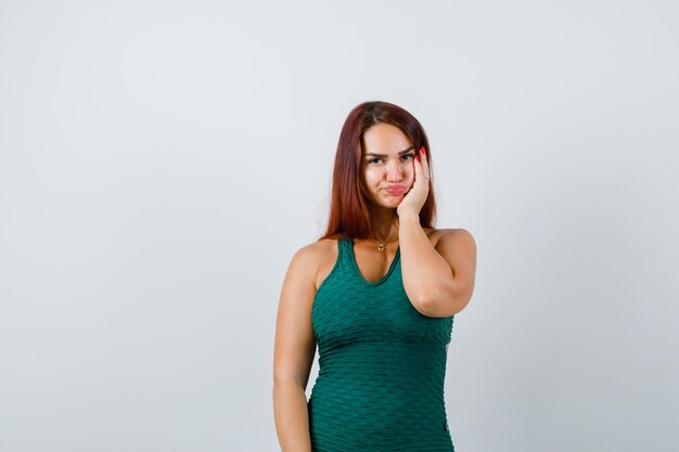 Young woman with long hair in a green bodycon