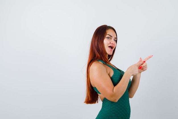 Young woman with long hair in a green bodycon