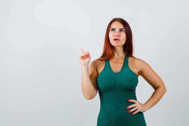 Young woman with long hair in a green bodycon