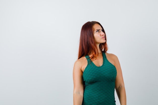 Young woman with long hair in a green bodycon