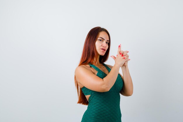 Young woman with long hair in a green bodycon