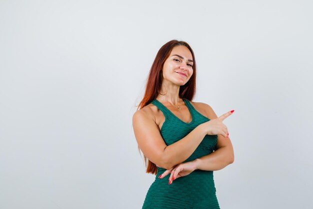 Young woman with long hair in a green bodycon