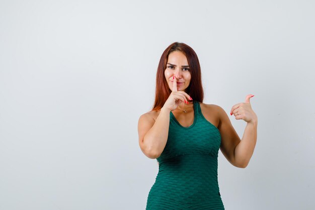 Young woman with long hair in a green bodycon