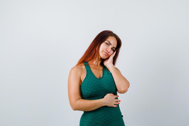 Young woman with long hair in a green bodycon