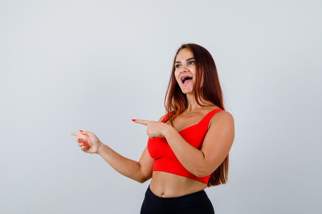 Young woman with long hair in an orange tank top