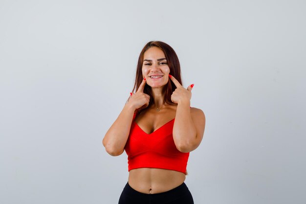 Young woman with long hair in an orange tank top