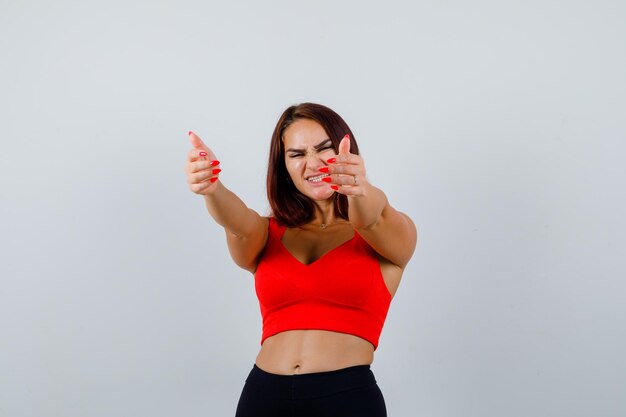 Young woman with long hair in an orange tank top