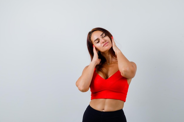 Young woman with long hair in an orange tank top