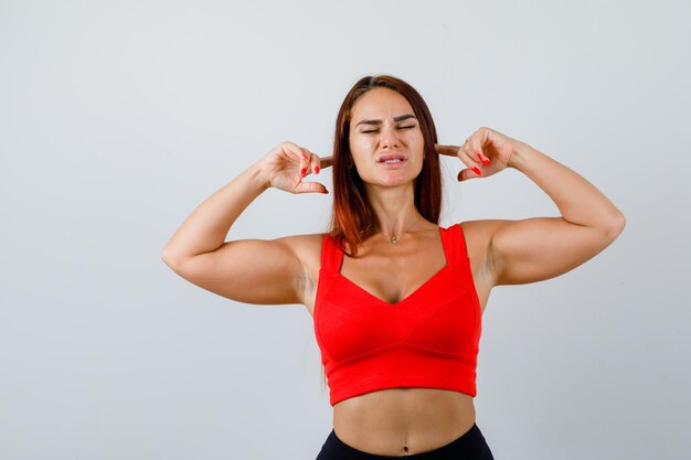 Young woman with long hair in an orange tank top