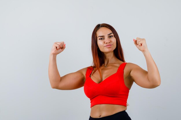 Young woman with long hair in an orange tank top