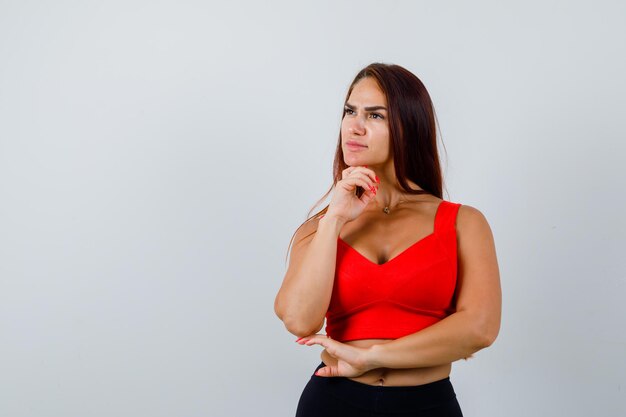 Young woman with long hair in an orange tank top