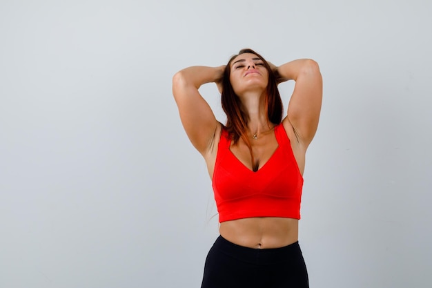 Young woman with long hair in an orange tank top