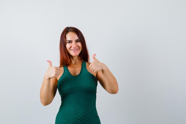 Free photo young woman with long hair wearing a green bodycon