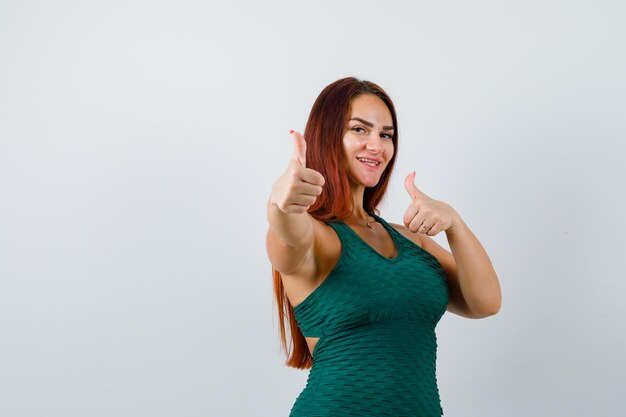 Young woman with long hair wearing a green bodycon